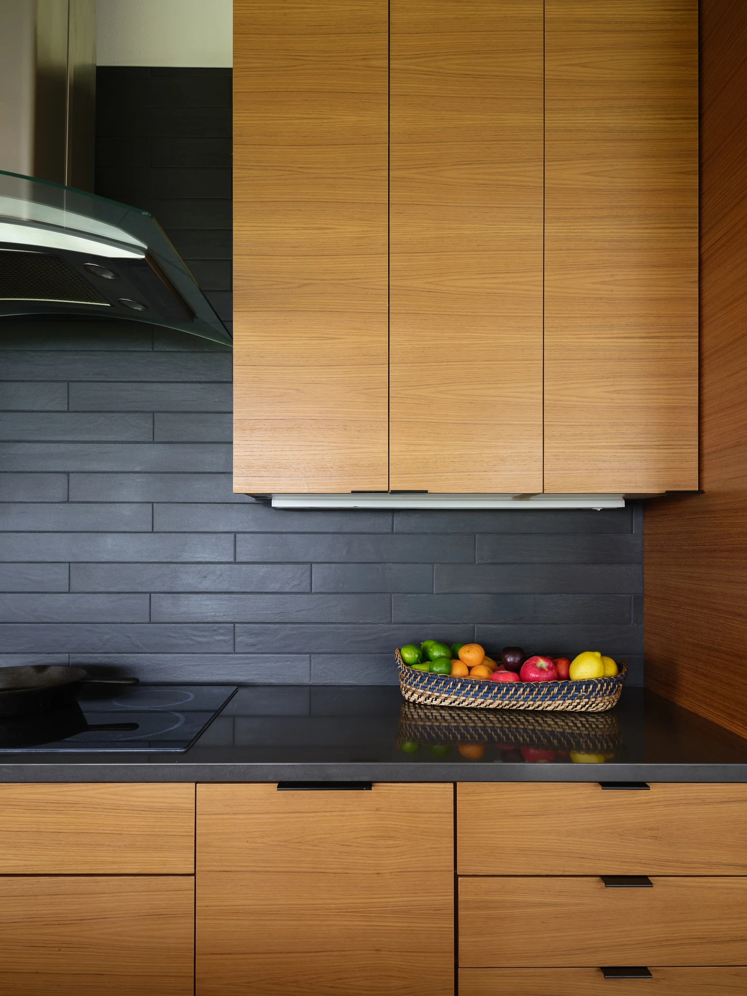 Kitchen detail with wood cabinetry, slate backsplash, and a fruit bowl — interior design photography Bozeman Montana, Bozeman Overlook